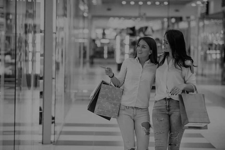 Two young women have a shopping day together in the supermarket